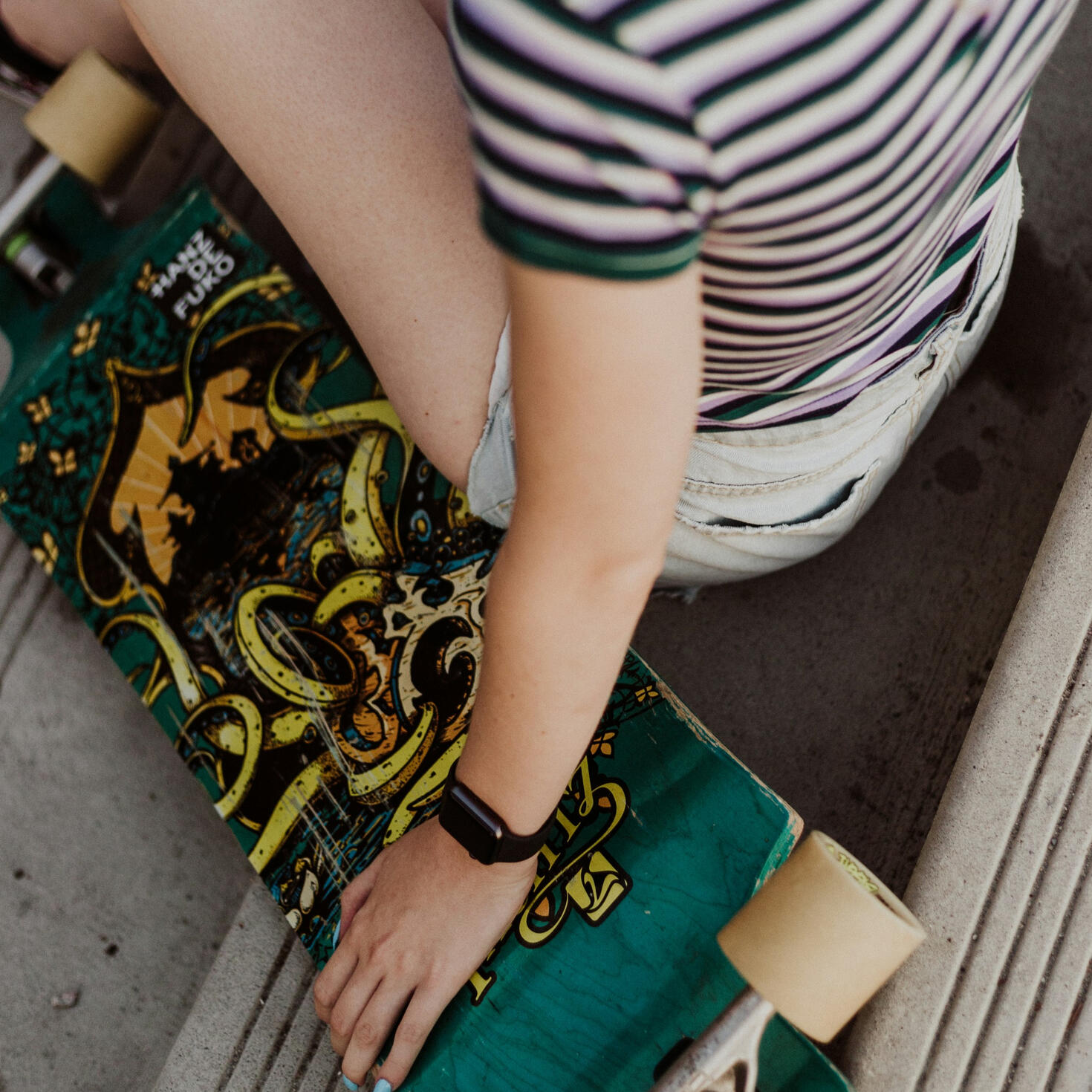 teen girl holding a skateboard