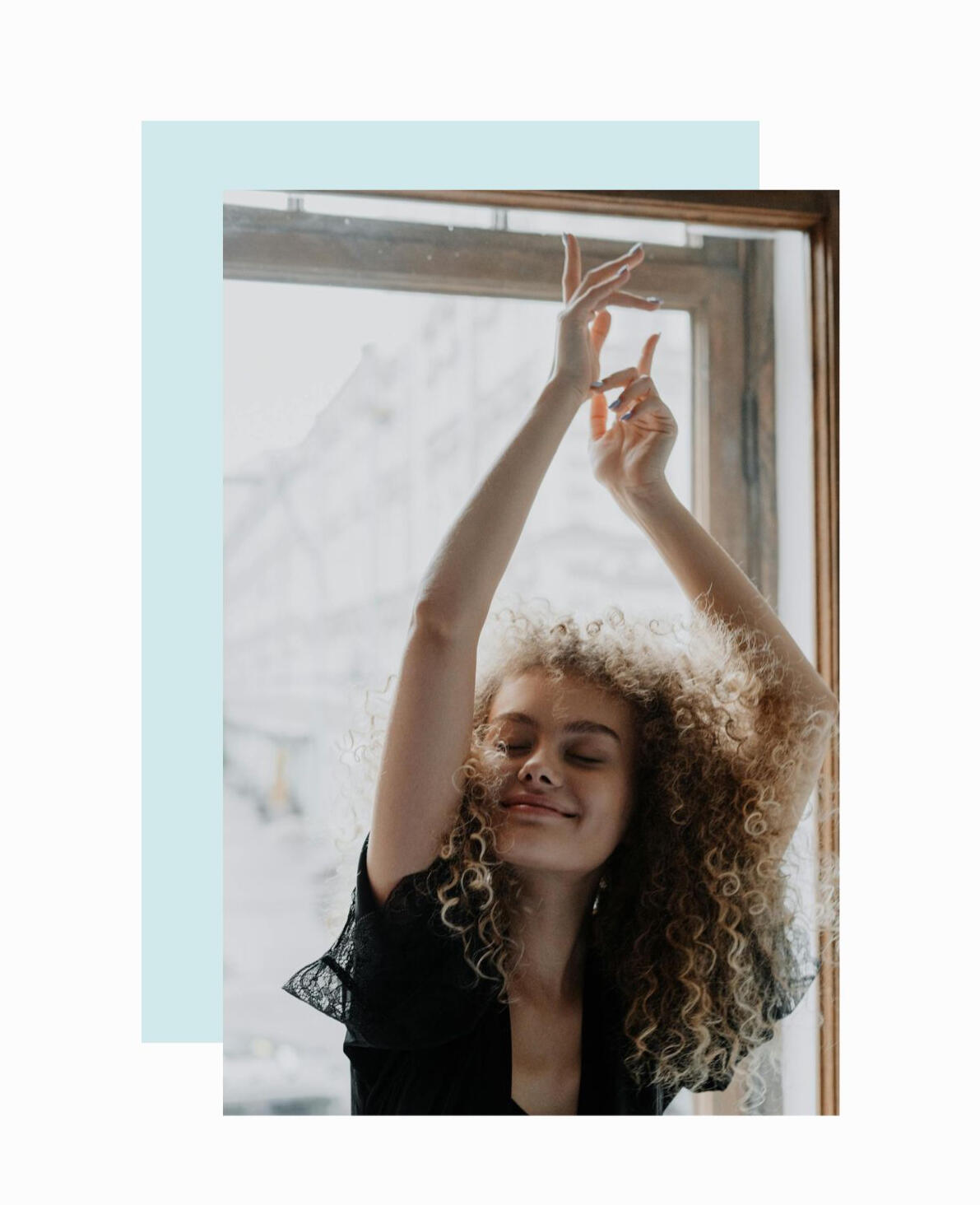 girl with arms raised smiling happily