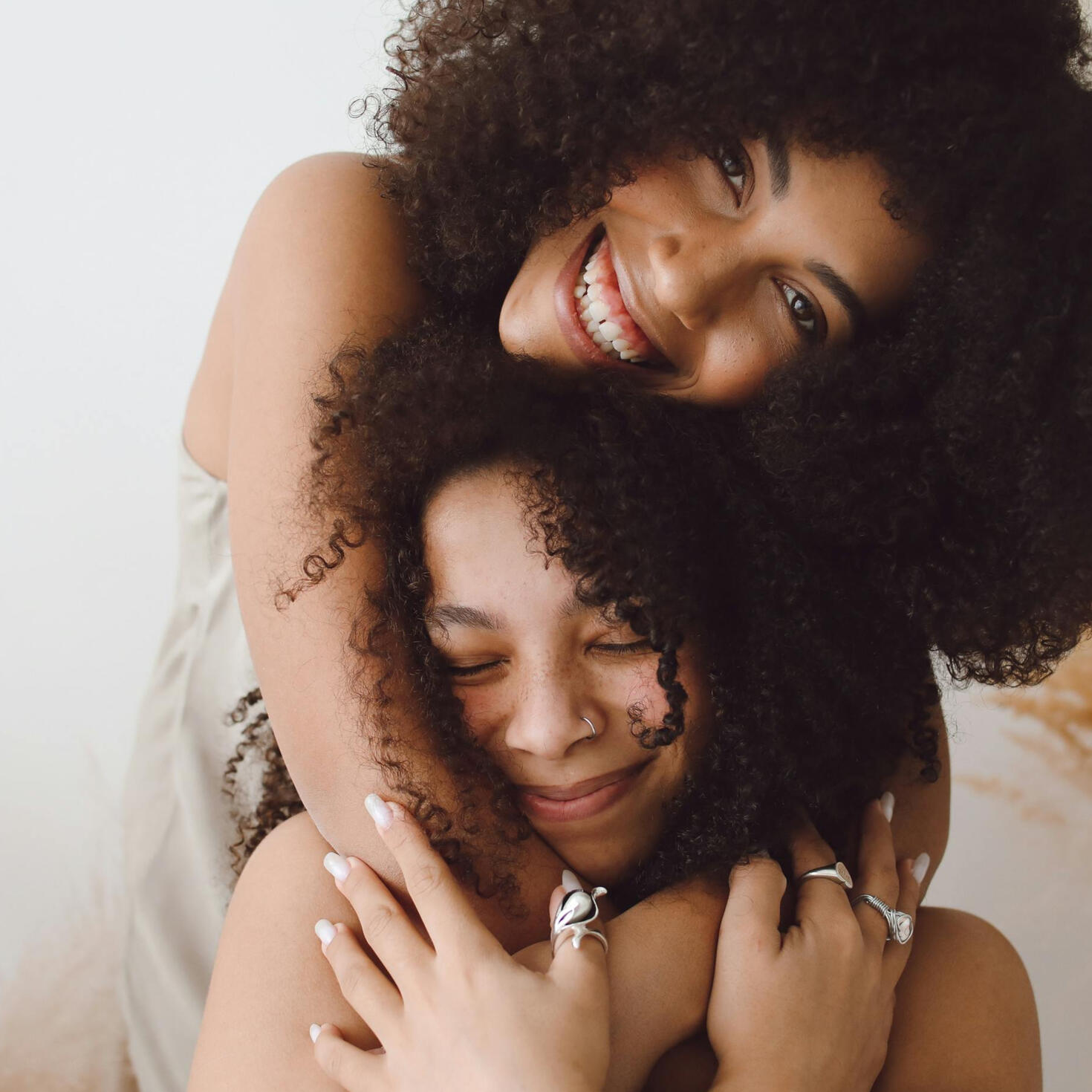 teenage girls smiling and hugging each other